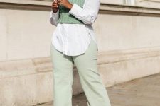 a white oversized shirt, light green jeans, a matching cropped waistcoat, snakeskin print shoes for a catchy look