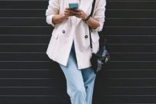 a white shirt, a white oversized corduroy blazer, blue cropped jeans, black booties and a black embellished bag