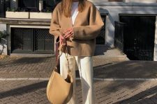 a white t-shirt, creamy trousers, white sneakers, a tan cardigan and a matching bag for the fall