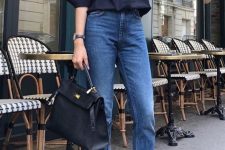 ablack shirt, blue slim leg jeans, navy vintage flat shoes and a black tote are a cool look for work