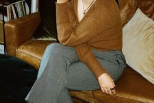an elegant French chic look with a rust-colored V-neck jumper, grey cropped trousers, rust-colored crocodile leather slingbacks