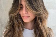long brunette locks with soft honey balayage and curtain bangs, with textures are incredibly beautiful