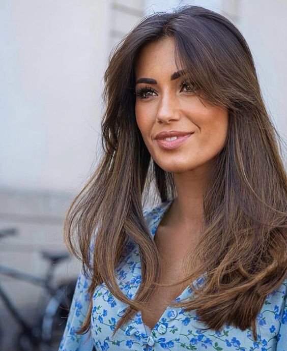 long dark brunette hair with texture and volume, with long curtain bangs looks incredibly chic and beautiful