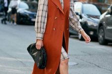 08 a plaid shirtdress with puff sleeves, tan lace up booties, a rust sleeveless coat and a black clutch for work