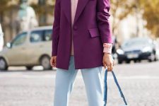 08 an elegant fall work outfit with a pink shirt, a purple blazer, blue flare pants, purple boots and a blue bag