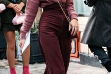 11 a dusty pink cahsmere turtleneck, burgundy high waisted trousers, white boots and a burgundy bag