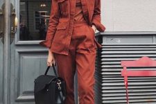 11 a rust-colored fall outfit with a turtleneck, high waisted trousers, a matching jacket, black boots and a bag is suitable for work