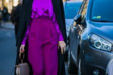 17 a refined fall work outfit with a silk purple blouse and high waisted palazzo trousers, white shoes, a black trench and a neutral bag