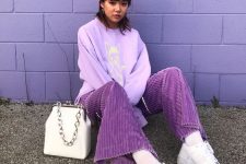 23 a lilac printed sweatshirt, a lilac beanie, purple corduroy pants, white snekaers and a white bag