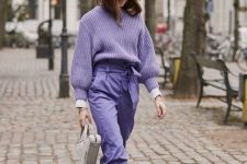 26 a monochromatic outfit with an oversized lavender sweater, high waisted trousers, white boots and a white bag