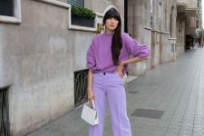 28 a pastel fall outfit with a purple jumper, lilac trousers, white shoes and a mini bag plus white earrings