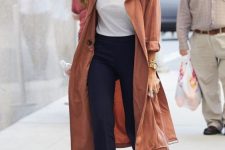 32 a white t-shirt, navy flare trousers, a rust trench and black boots worn by Jessica Alba
