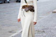 34 a white sweater midi dress with long sleeves and a high neckline, a brown belt, a brown printed waist bag, black boots