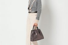 With beige cropped trousers, patent leather bag and black low heeled boots