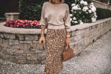 With beige hat, leopard printed midi skirt, bag and white mules