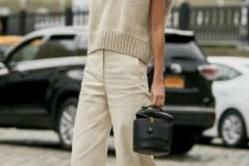 With beige loose pants, black leather bag and black ankle strap shoes