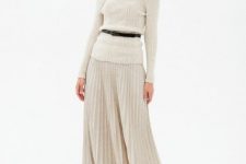 With black belt, pleated midi skirt and black and beige ankle strap high heels