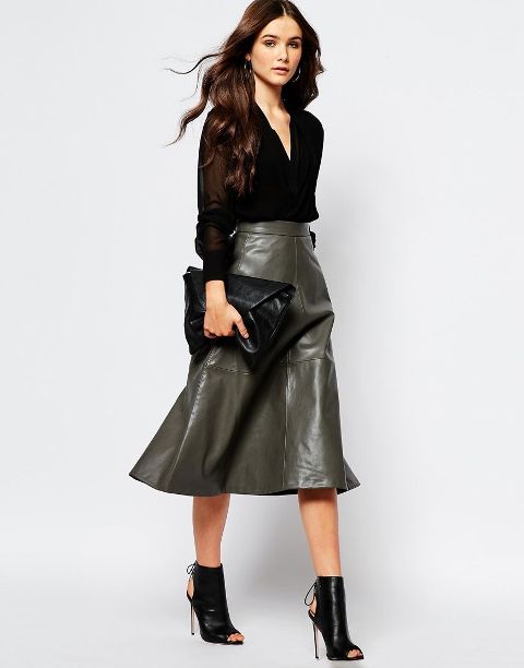 With black button down shirt, black leather clutch and black cutout boots