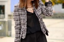 With black button down shirt, black mini skirt and bag