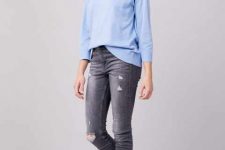 With gray distressed skinny jeans and metallic sneakers