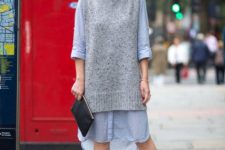 With light blue loose dress, black clutch and brown and blue sandals