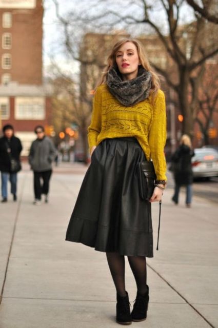 With mustard yellow loose sweater, faux fur scarf, black bag and black suede ankle boots