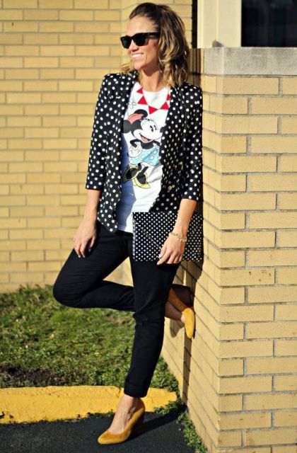With printed t-shirt, black pants, black and white polka dot clutch and yellow suede shoes