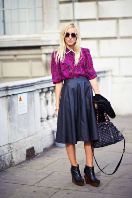 With purple printed shirt, black platform ankle boots and chain strap bag