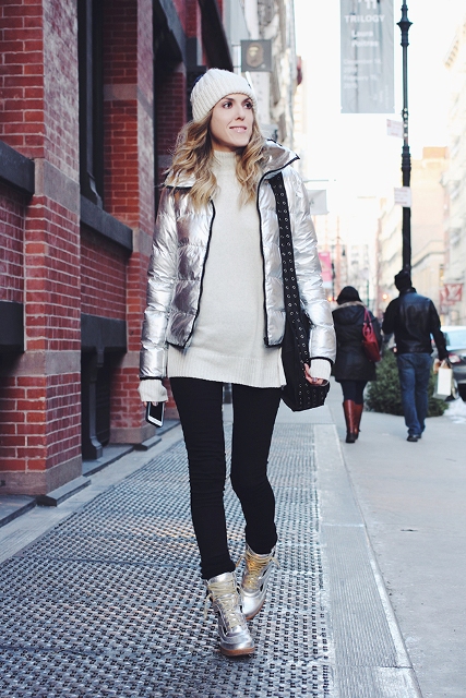 With white long sweater, white hat, black leggings, black bag and silver mid calf boots