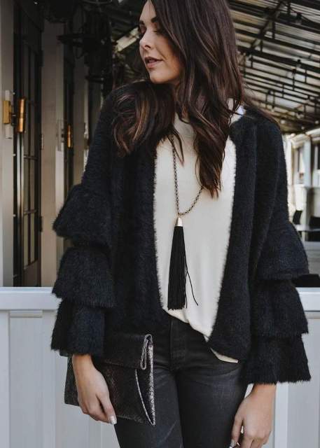 With white loose sweater, clutch and dark gray jeans