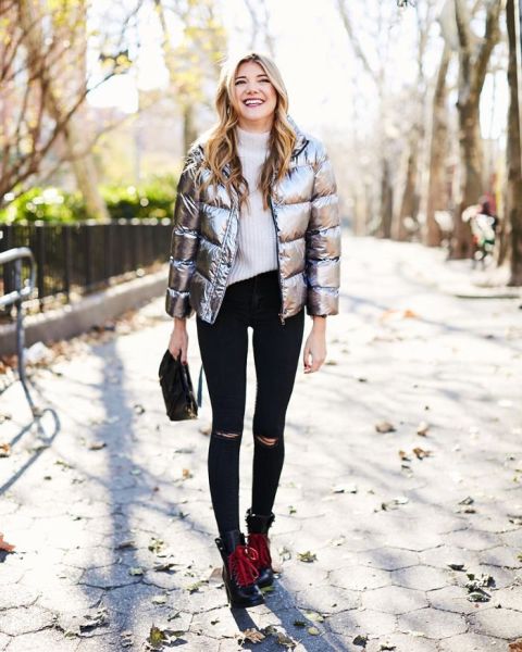 With white sweater, distressed skinny jeans, black bag and black and red boots