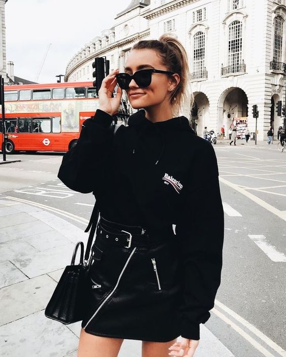 a black hoodie, a black zip mini leather skirt, a black bag for a sexy and bold fall look
