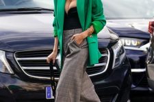 a bold outfit with a black strapless bodusuit, an apple grene oversized blazer, grey plaid palazzo pants and a black bag