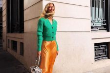 a bright and stylish outfit with an apple green cardigan, a marigold slip skirt, yellow Mary Jane shoes and a snakeskin print bag