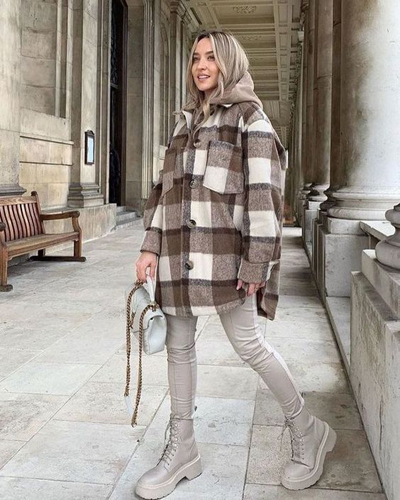 a brown hoodie, a plaid shirt jacket, off-white leather leggings, matching boots and a grey bag