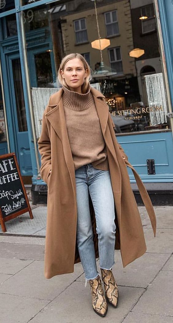 a brown turtleneck and a midi coat, blue jeans, beige snakeskin print boots for a lovely fall look