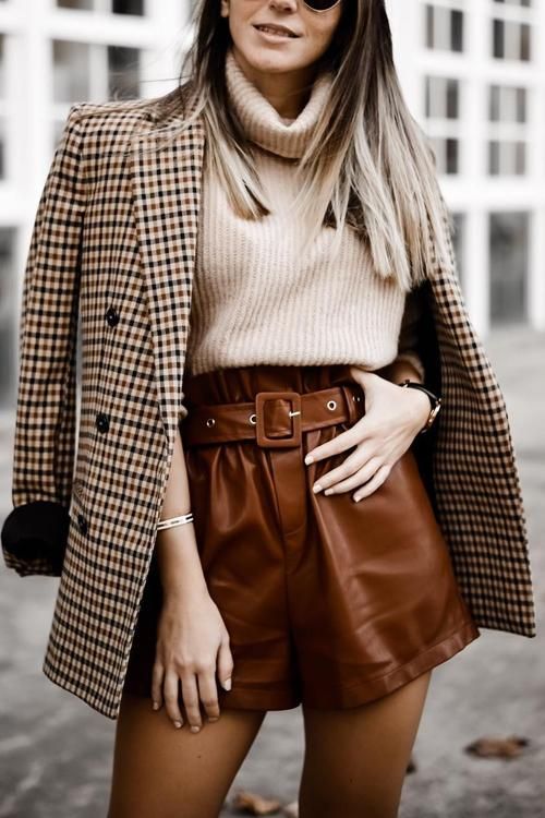 a creamy turtleneck, cognac leather shorts, tights, a tan plaid blazer for a stylish fall look suitable for work