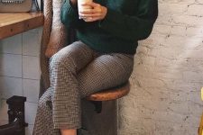 a dark green turtleneck, plaid trousers, black sneakers and a tan fuzzy coat for a cold day