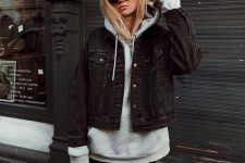 a grey oversized hoodie, black leather leggings, a black cropped denim jacket, a black bag for a stylish look
