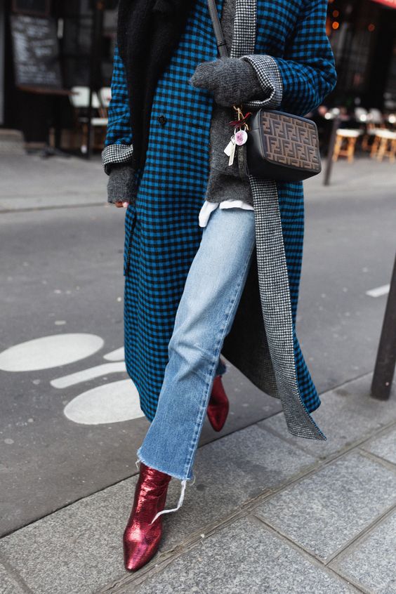 a grey sweater over a white t-shirt, blue jeans, blue plaid coat, red metallic boots, a black scarf and a printed bag