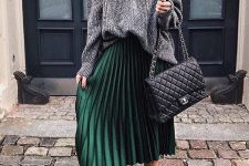 a grey turtelenck sweater, a green pleated midi skirt, black combat boots and a black bag for fall