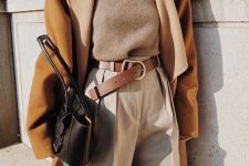 a grey turtleneck, creamy high waisted pants, a brown belt, an amber coat, a black bag for the fall