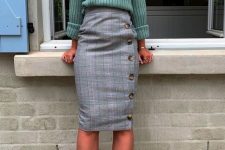a pale green jumper, a grye plaid midi skirt on buttons, green heels and cool jewelry for work