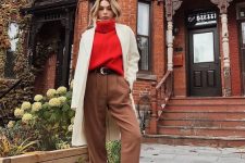 a red turtleneck sweater, brown pants, snakeskin print booties, a creamy short coat for a cold fall day