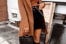 a rust ribbed turtleneck, a black mini skirt, black knee boots, a rust knee coat and a black bucket bag for a chic look
