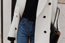 a simple and contrasting look with a black turtleneck, blue high rise jeans, a white coat with black buttons and a black tote