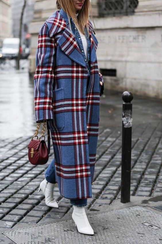 a white turtleneck, blue jeans, white boots, a blue and red plaid midi coat and a burgundy bag for a bold fall look
