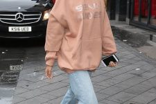 an oversized pink hoodie paired with light blue jeans and silver shoes is a fresh idea to make your look more girlish