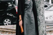 04 a trendy minimalist look with a black leather midi dress with an asymmetrical skirt, a long black cardigan and black shoes
