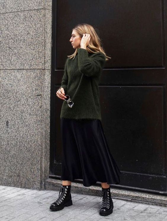 a dark green sweater, a black slip midi, black hiking boots for a comfy and cool winter look